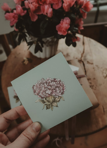Light purple flower on light blue small flat card
