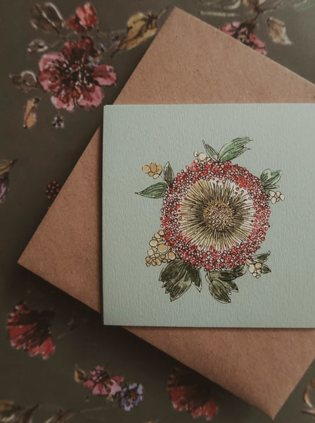Green flower on light blue small flat card