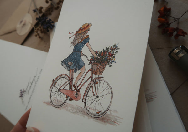 Girl on a bicycle / postcard